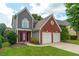 Charming two-story home featuring brick and gray siding, a well-manicured lawn, and a two-car garage at 1265 Birchwood Ln, Roswell, GA 30076