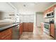 Bright kitchen featuring stainless steel appliances, granite countertops and wooden cabinets at 1265 Birchwood Ln, Roswell, GA 30076
