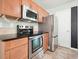 Modern kitchen appliances with a stainless-steel refrigerator, oven, and dark granite countertops at 1265 Birchwood Ln, Roswell, GA 30076