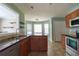Spacious kitchen with stainless steel appliances, tile floor and bay window seating at 1265 Birchwood Ln, Roswell, GA 30076