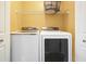 Modern laundry room with white washer and dryer set and wire shelving at 1265 Birchwood Ln, Roswell, GA 30076