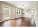 Open-concept living room featuring hardwood floors, modern lighting, and a bright window view at 1265 Birchwood Ln, Roswell, GA 30076
