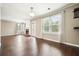 Spacious living room featuring a brick fireplace, large window and hardwood floors at 1265 Birchwood Ln, Roswell, GA 30076