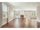 Spacious living room featuring hardwood floors, a fireplace, and natural light from large windows at 1265 Birchwood Ln, Roswell, GA 30076