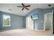 Main bedroom with vaulted ceiling, tv, and two doorways leading to other rooms at 1265 Birchwood Ln, Roswell, GA 30076