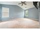 Spacious main bedroom with plush carpet, a ceiling fan, and ample natural light at 1265 Birchwood Ln, Roswell, GA 30076