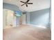 Bright main bedroom with two doorways, tv, carpeted floor and neutral walls at 1265 Birchwood Ln, Roswell, GA 30076
