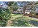 Serene backyard with green grass and a wooden fence, surrounded by trees at 2530 Parkdale Pl, Atlanta, GA 30305