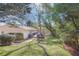 Expansive backyard with lush green grass, mature trees, and a spacious wooden deck at 2530 Parkdale Pl, Atlanta, GA 30305
