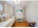 Light-filled bedroom with a daybed, patterned wallpaper, hardwood floors, and neutral-toned decor at 2530 Parkdale Pl, Atlanta, GA 30305