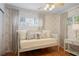 Light-filled bedroom with a daybed, patterned wallpaper, hardwood floors, and neutral-toned decor at 2530 Parkdale Pl, Atlanta, GA 30305