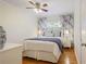 Comfortable bedroom with hardwood floors, a ceiling fan, blue and white patterned curtains at 2530 Parkdale Pl, Atlanta, GA 30305