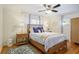 Cozy bedroom with a wicker bed, decorative pillows, hardwood floors, and a ceiling fan at 2530 Parkdale Pl, Atlanta, GA 30305