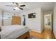 Comfortable bedroom with hardwood floors, ceiling fan and access to the ensuite bathroom and hallway at 2530 Parkdale Pl, Atlanta, GA 30305