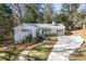 Charming single-story home with a white exterior, well-manicured lawn, and a long driveway at 2530 Parkdale Pl, Atlanta, GA 30305