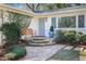Inviting front entrance with stone steps, a cozy bench, and lush landscaping, enhancing curb appeal at 2530 Parkdale Pl, Atlanta, GA 30305