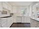 Well-lit kitchen features white cabinets, modern appliances, and tile flooring for easy maintenance at 2530 Parkdale Pl, Atlanta, GA 30305