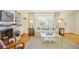 Bright living room features hardwood floors, a fireplace, built-in shelves, and a large window at 2530 Parkdale Pl, Atlanta, GA 30305
