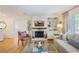 Spacious living room with fireplace, built-in shelving, and a large window for natural light at 2530 Parkdale Pl, Atlanta, GA 30305
