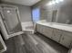 Bathroom featuring shower, tub, vanity with white cabinets, and gray vinyl flooring at 263 Northwind Dr, Stockbridge, GA 30281