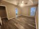 Bright bedroom featuring tray ceiling, ceiling fan, double windows and gray vinyl flooring at 263 Northwind Dr, Stockbridge, GA 30281