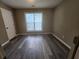 Bedroom with wood-look flooring and a large window offering natural light at 263 Northwind Dr, Stockbridge, GA 30281