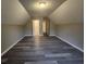 Large bonus room with wood-look flooring featuring a doorway to a hallway at 263 Northwind Dr, Stockbridge, GA 30281