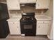 Functional kitchen featuring new luxury vinyl plank flooring, black appliances and neutral paint at 263 Northwind Dr, Stockbridge, GA 30281