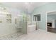Bathroom with glass shower, white marble tiling, a soaking tub and a fireplace in background at 3183 Robinwood Trl, Decatur, GA 30034