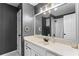 Bathroom featuring white cabinets, a white sink, decorative nautical themed wall decor, and a mirror at 3183 Robinwood Trl, Decatur, GA 30034