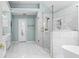 Modern bathroom with white marble tile, a glass-enclosed shower with gold fixtures, and a soaking tub at 3183 Robinwood Trl, Decatur, GA 30034