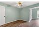Comfortable bedroom with a ceiling fan, laminate floors, and great natural light at 3183 Robinwood Trl, Decatur, GA 30034