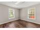 An empty bedroom features wood floors, with two windows at 3183 Robinwood Trl, Decatur, GA 30034