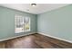 Cozy bedroom with wood-look flooring and a bright window at 3183 Robinwood Trl, Decatur, GA 30034