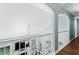 Upstairs hallway features beautiful wood floors, white railings, and multiple windows at 3183 Robinwood Trl, Decatur, GA 30034