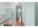 Hallway featuring an arched window, white railing, and light turquoise colored walls at 3183 Robinwood Trl, Decatur, GA 30034