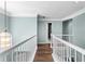 Hallway with a white railing and light fixture with views into other rooms of the house at 3183 Robinwood Trl, Decatur, GA 30034