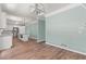 Open-concept living area with wood floors, modern light fixtures, and access to kitchen at 3183 Robinwood Trl, Decatur, GA 30034