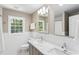 Bright bathroom with double sinks, marble countertop, and white tiled walls, offering a clean and modern aesthetic at 3380 E Wood Valley Rd, Atlanta, GA 30327