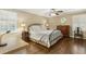 Comfortable bedroom features hardwood floors, a ceiling fan, and natural light streaming through shuttered windows at 3380 E Wood Valley Rd, Atlanta, GA 30327