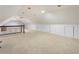 Expansive upper bonus room with neutral carpeting, bright lighting, and plenty of space for activities at 3380 E Wood Valley Rd, Atlanta, GA 30327