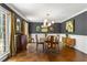 Charming dining room with hardwood floors, modern chandelier, and large windows offering natural light at 3380 E Wood Valley Rd, Atlanta, GA 30327