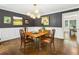 Elegant dining room with dark walls, white wainscoting, hardwood floors, and stylish lighting for formal gatherings at 3380 E Wood Valley Rd, Atlanta, GA 30327