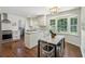 Modern eat-in kitchen with white cabinetry, stainless steel appliances, granite countertops, and a cozy breakfast nook at 3380 E Wood Valley Rd, Atlanta, GA 30327
