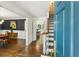 Bright foyer featuring hardwood floors and an open view into the dining room, with stairs to the upper level at 3380 E Wood Valley Rd, Atlanta, GA 30327