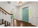 Inviting foyer with hardwood floors, natural light from side windows, and a pop of color from a stylish teal door at 3380 E Wood Valley Rd, Atlanta, GA 30327
