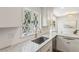 Well-lit kitchen with granite countertops, white cabinets, stainless steel sink, and modern faucet at 3380 E Wood Valley Rd, Atlanta, GA 30327