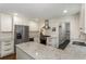 Modern kitchen features white cabinets, stainless steel appliances, granite countertops, and ample storage at 3380 E Wood Valley Rd, Atlanta, GA 30327