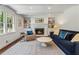 Cozy living room with a fireplace, built-in bookshelves, and comfortable seating, perfect for relaxing and entertaining at 3380 E Wood Valley Rd, Atlanta, GA 30327