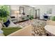 Bright living room featuring a large window, stylish furnishings, and a unique patterned rug on hardwood flooring at 3380 E Wood Valley Rd, Atlanta, GA 30327